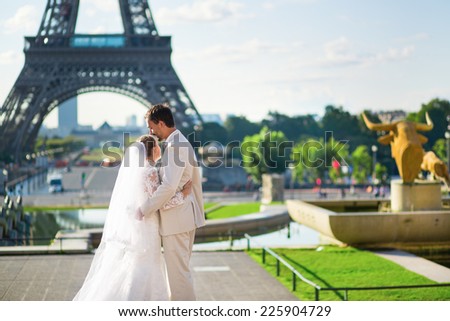 Beautiful just married couple in Paris near the Eiffel tower