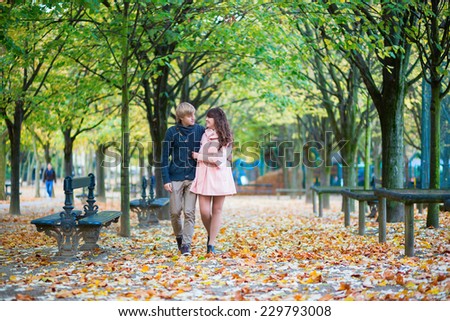 Beautiful loving couple walking together on a fall day in Paris