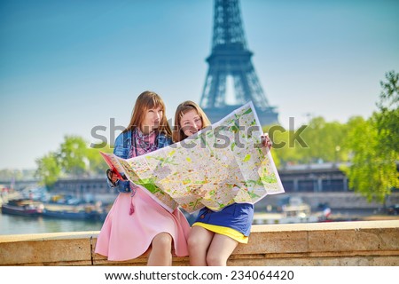 Girls in Paris near the Eiffel tower looking for direction