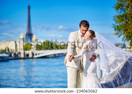 Beautiful just married couple in Paris near the Eiffel tower in Paris