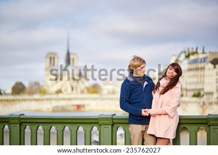 Happy dating couple walking in Paris together