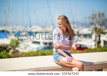 Nice looking young girl enjoying her vacation by the sea
