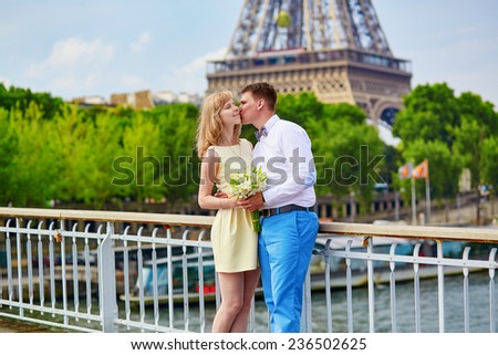 Young just married couple in Paris near the Eiffel tower