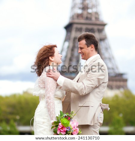 Wedding in Paris. Happy just married couple hugging near the Eiffel Tower
