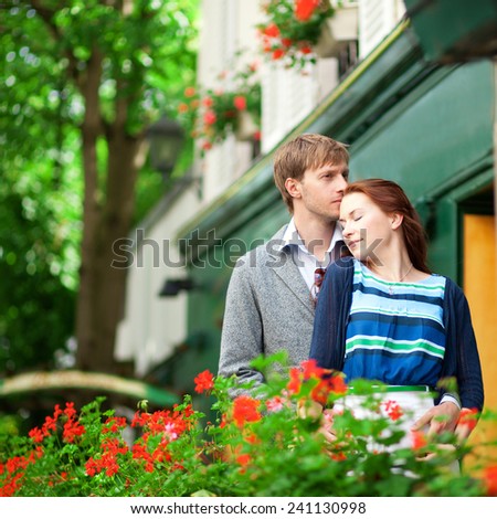 Man and woman together on balconyof their house or hotel with blossoming geranium and nice view