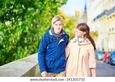 Young dating couple in Paris near the Seine on a nice spring day