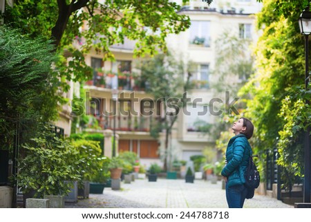 Young girl walking in Paris, looking up