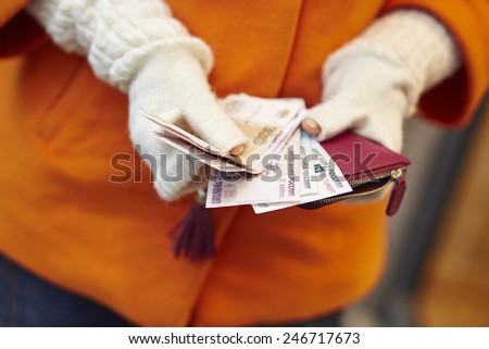 Woman hands holding purse with Russian roubles, financial crisis in Russia concept
