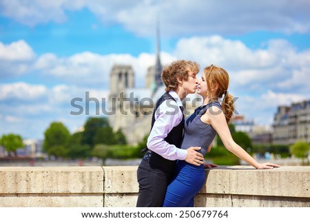 Dating couple near Notre-Dame enjoying warm sunny day in Paris