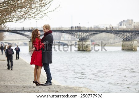 Romantic couple in love having a date near Pont des Arts in Paris