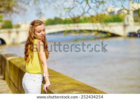 Beautiful young girl walking in Paris on a sunny summer or spring day