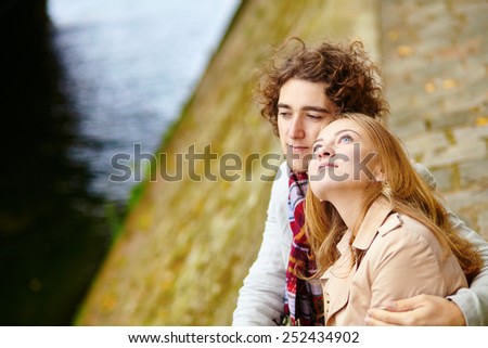 Young loving couple in Paris, on the Seine embankment