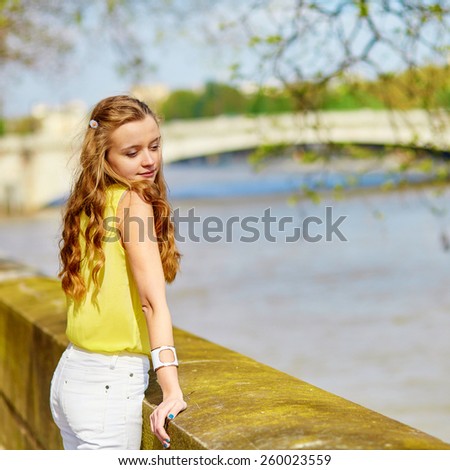 Beautiful young girl walking in Paris on a sunny summer or spring day