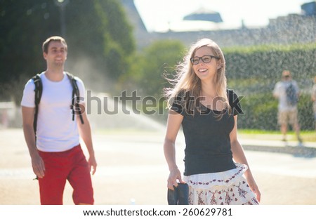 Couple enjoing water spray on a hot day