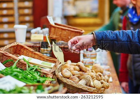 Man buying fresh mushrooms on London farmer agricultural market
