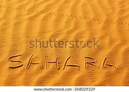 Word Sahara written on the sand in sand dunes in the Sahara Desert, Merzouga, Morocco