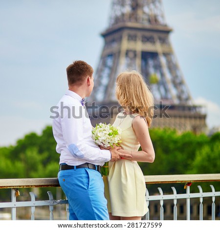 Young just married couple in Paris near the Eiffel tower