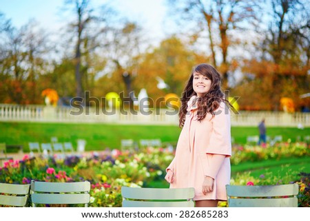 Beautiful young woman on a bright fall day walking in Paris in the Luxembourg gardens