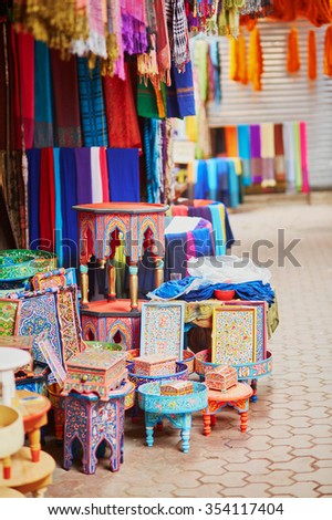 Selection of wooden furniture on a traditional Moroccan market (souk) in Marrakech, Morocco