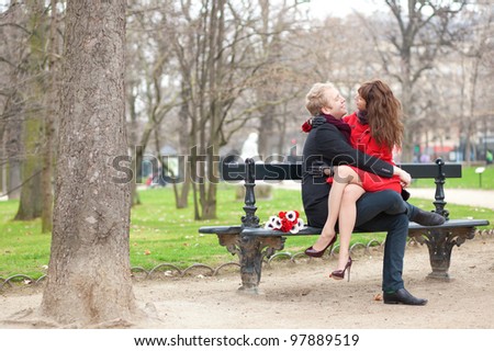 Happy romantic couple hugging on a bench