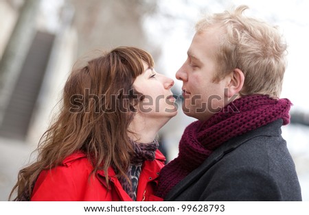 Romantic couple in love kissing outdoors