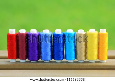 Colorful spools of thread in a row