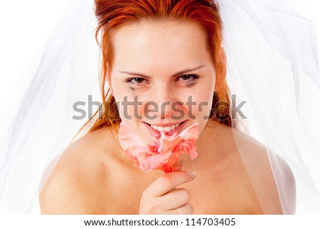 a beautiful red-haired bride cries, holding a flower isolated on white background