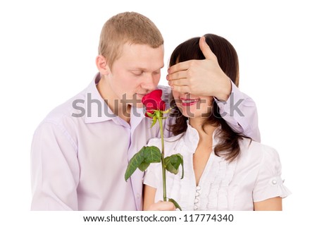 the guy gives a girl a rose, makes a proposal isolated on white background