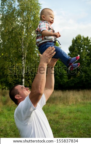 father throws to the top the son on the nature
