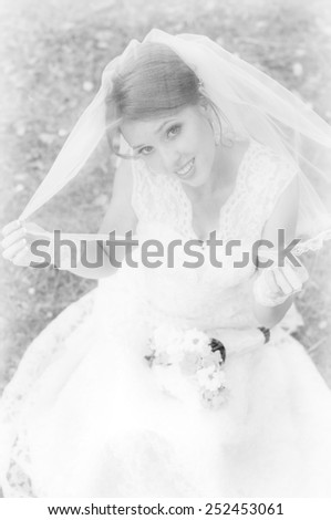 Beautiful bride with a bouquet of black white on nature background