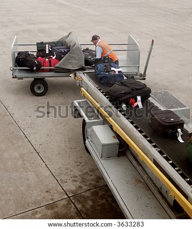 A man is loading luggage onto airplane