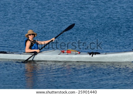 A smiling attractive young woman in sea kayak. Mission Bay, San Diego, California