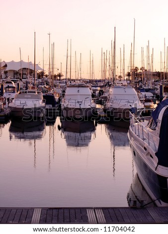 Marina view of Vilamoura near Quarteira City, Algarve, Portugal, with it's many cool boats, at sunset.