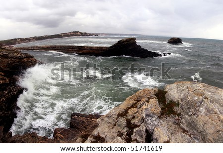 View of a furious wave hitting the cliffs on the coastline of Alentejo, Portugal.