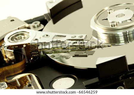 close view detail of the inside of a computer harddisk isolated on a white background.