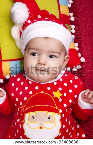 View of a newborn baby on a Christmas suit.