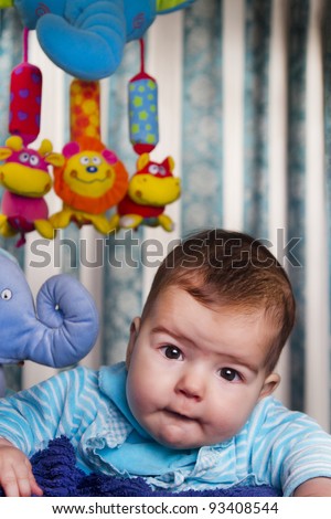 View of a newborn baby with a stuffed toy.