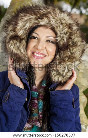 Young beautiful woman with big hairy winter jacket.