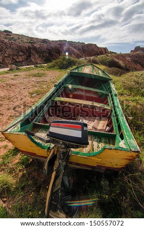 Close up view of a traditional fishing boat on land.