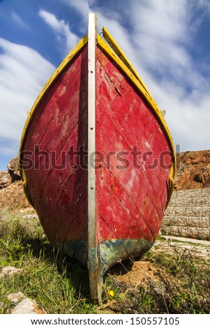 Close up view of a traditional fishing boat on land.