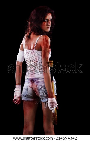 Fearful young street fighter girl on a black background.
