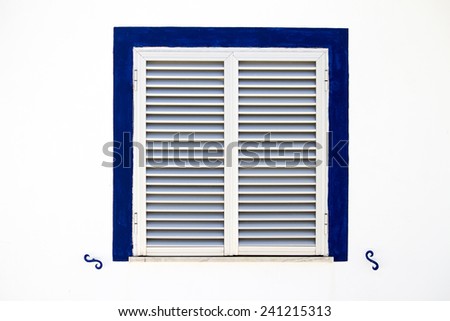 Close up view of a modern aluminum window with a blue frame.