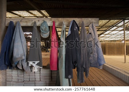 View of construction worker dirty clothes hanging.