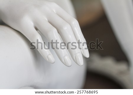 Close up view of white mannequins hand on a museum.