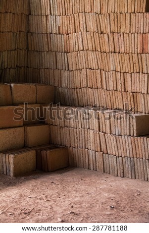 Close view of a pile of traditional mud bricks production.