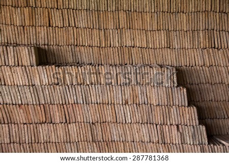 Close view of a pile of traditional mud bricks production.
