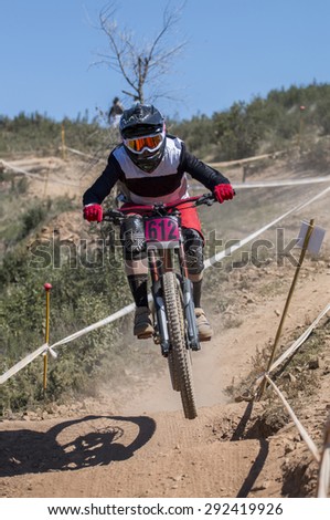 Downhill competition, Biker rides fast in the countryside.