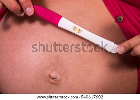 Close view of a girl with pregnancy test.