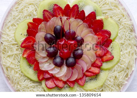 Round fruit salad. Delicious and tasty fruit salad packed in big container