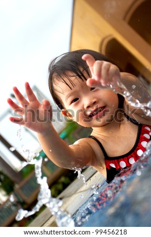 Little Girl Playing water and learn to swim